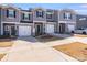 Gray townhouses with white garage doors and landscaping at 3021 Belstock Ct, Charlotte, NC 28216