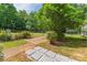 Backyard with a short stone walkway and lush landscaping at 3035 Agean Ln, York, SC 29745