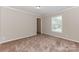 Bedroom with neutral carpet and walls, a window providing natural light and closet access at 3035 Agean Ln, York, SC 29745