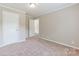 Bedroom showing a neutral carpet and walls, and a door to another room at 3035 Agean Ln, York, SC 29745