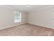 This is a bedroom with neutral paint, carpeting and trim, a window, and a ceiling-mounted light at 3035 Agean Ln, York, SC 29745