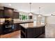 Kitchen with a central island, dark cabinets, stainless steel appliances, and wood flooring at 3035 Agean Ln, York, SC 29745