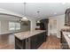 A kitchen featuring dark cabinets, an island, stainless appliances, and an open design at 3035 Agean Ln, York, SC 29745