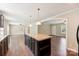 Open-concept living area featuring dark cabinets, granite countertops, and stainless appliances at 3035 Agean Ln, York, SC 29745