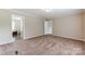 Inviting main bedroom featuring plush carpet and a doorway leading to the ensuite bathroom at 3035 Agean Ln, York, SC 29745