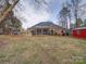 House's back view, featuring a screened porch and yard at 3119 Drake Ln, Monroe, NC 28110