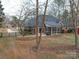 Home's backyard with screened porch and spacious yard at 3119 Drake Ln, Monroe, NC 28110