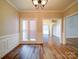 Hardwood floor dining room with chandelier and view into adjacent rooms at 3119 Drake Ln, Monroe, NC 28110