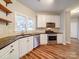 Modern kitchen with white cabinets, granite countertops, and stainless steel appliances at 3119 Drake Ln, Monroe, NC 28110