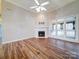 Living room with hardwood floors, fireplace, and large windows at 3119 Drake Ln, Monroe, NC 28110