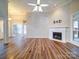 Living room features hardwood floors, fireplace, and access to sunroom at 3119 Drake Ln, Monroe, NC 28110