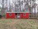 Red storage shed with a porch and windows at 3119 Drake Ln, Monroe, NC 28110