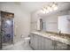 Elegant bathroom featuring a glass shower with marble tile, a granite countertop, and modern fixtures at 315 Arlington Ave # 604, Charlotte, NC 28203