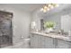 Modern bathroom with marble shower, dual vanities, granite counters, and hexagonal tile floor at 315 Arlington Ave # 604, Charlotte, NC 28203