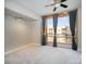 Empty bedroom with a ceiling fan, large window with a view and neutral carpet at 315 Arlington Ave # 604, Charlotte, NC 28203