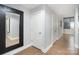 Bright hallway with hardwood floors, white doors, and a large decorative mirror at 315 Arlington Ave # 604, Charlotte, NC 28203