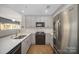 Stylish kitchen with gray cabinets, stainless steel refrigerator, and modern black gas range at 315 Arlington Ave # 604, Charlotte, NC 28203