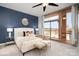 Cozy main bedroom featuring an accent wall, ceiling fan, and balcony with city views at 315 Arlington Ave # 604, Charlotte, NC 28203