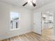 Bedroom with wood flooring, ceiling fan and view of kitchen at 315 W 2Nd St, Cherryville, NC 28021