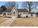 Newly renovated craftsman home with gray painted brick and a landscaped lawn at 315 W 2Nd St, Cherryville, NC 28021