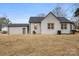 Rear view of the house, showcasing a gray brick exterior and attached garage at 315 W 2Nd St, Cherryville, NC 28021