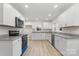 Modern kitchen with white cabinets, granite counters, and stainless steel appliances at 315 W 2Nd St, Cherryville, NC 28021