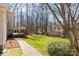 Private backyard with a wooden deck, lush green lawn, mature trees, and a storage shed at 3153 Wimbledon Ln, Rock Hill, SC 29732