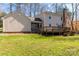 Backyard view showcasing the home's exterior with a deck, screened-in porch, and lush green space at 3153 Wimbledon Ln, Rock Hill, SC 29732