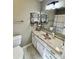 Bathroom with a white vanity, light fixtures, and a decorative mirror shelf at 3153 Wimbledon Ln, Rock Hill, SC 29732