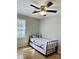 Bedroom featuring a wrought iron day bed with a ceiling fan and a large window at 3153 Wimbledon Ln, Rock Hill, SC 29732