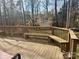 Inviting wooden deck with built-in seating, perfect for enjoying peaceful views of the wooded backyard at 3153 Wimbledon Ln, Rock Hill, SC 29732