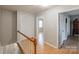 Upstairs hallway featuring hardwood floors and access to several rooms and closet at 3153 Wimbledon Ln, Rock Hill, SC 29732