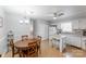 Bright kitchen featuring a center island, a wooden table, and white appliances and cabinets at 3153 Wimbledon Ln, Rock Hill, SC 29732