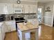 Kitchen boasts ample counter space, stainless steel appliances, and a center island with seating at 3153 Wimbledon Ln, Rock Hill, SC 29732