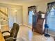 Inviting living room with natural light, beautiful hardwood floors, and a classic writing desk at 3153 Wimbledon Ln, Rock Hill, SC 29732