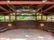 Outdoor amphitheater featuring a brick stage area, wooden bench seating, and wooden overhead support beams at 3207 Oliver Stanley Trl, Lancaster, SC 29720