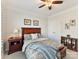 Cozy bedroom features a ceiling fan, bedside table with lamp, and elegant decor at 3207 Oliver Stanley Trl, Lancaster, SC 29720