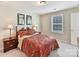 Well-lit bedroom with floral bedding, shuttered window, and bedside tables at 3207 Oliver Stanley Trl, Lancaster, SC 29720