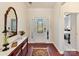 Welcoming entryway featuring hardwood floors, a decorative mirror, and a view into the bedroom at 3207 Oliver Stanley Trl, Lancaster, SC 29720