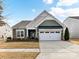 Charming single-Gathering home with a well-manicured lawn and an attached two-car garage in daylight at 3207 Oliver Stanley Trl, Lancaster, SC 29720