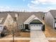 Aerial view of a green house with a two car garage, well maintained landscaping and a concrete driveway at 3207 Oliver Stanley Trl, Lancaster, SC 29720