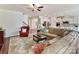 Open-concept living room featuring hardwood floors, a ceiling fan, and seamless access to the kitchen at 3207 Oliver Stanley Trl, Lancaster, SC 29720