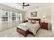 Sunlit main bedroom with a ceiling fan, plantation shutters, and elegant furnishings at 3207 Oliver Stanley Trl, Lancaster, SC 29720