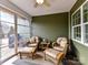 Relaxing sunroom featuring wicker chairs, ottoman, and a ceiling fan for a comfortable and inviting space at 3207 Oliver Stanley Trl, Lancaster, SC 29720