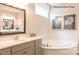 Elegant bathroom with corner soaking tub, vanity with quartz top, and framed art at 3539 Rapport Ct # 022, Lancaster, SC 29720