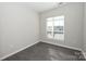 Bright bedroom with hardwood floors and large window at 3630 N Davidson St, Charlotte, NC 28205