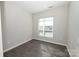 Bright bedroom with hardwood floors and large window at 3630 N Davidson St, Charlotte, NC 28205