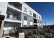 Modern apartment building with gray and white exterior, balconies, and outdoor seating at 3630 N Davidson St, Charlotte, NC 28205