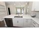 Open concept kitchen with island, stainless steel appliances, and white cabinets at 3630 N Davidson St, Charlotte, NC 28205