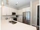 Modern kitchen with white cabinets, stainless steel appliances, and quartz countertops at 3630 N Davidson St, Charlotte, NC 28205